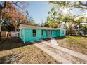 Neat teal house with a spacious yard and driveway at 7256 Pinehurst Dr, Spring Hill, FL 34606
