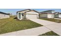 House exterior with a light-colored garage door and neatly kept lawn at 14036 Crutchfield Ct, Parrish, FL 34219