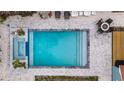Refreshing pool with a spa and surrounding stone patio at 2514 Beach S Blvd, Gulfport, FL 33707