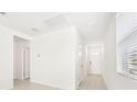 Bright and airy entryway with tile floors and neutral colors at 14037 Crutchfield Ct, Parrish, FL 34219