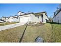 Newly built home with a two-car garage and landscaped lawn at 3902 Radiant Mountain Dr, Plant City, FL 33565