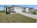 Two-story house with a two-car garage and well-manicured lawn at 3916 Radiant Mountain Dr, Plant City, FL 33565