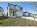 Two-story house with gray siding, two-car garage, and landscaping at 3919 Radiant Mountain Dr, Plant City, FL 33565