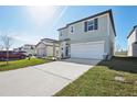 Two-story house with gray siding, attached garage, and landscaping at 3919 Radiant Mountain Dr, Plant City, FL 33565