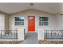 Red front door with sidelights and small porch at 3531 Oxford Dr, Holiday, FL 34691