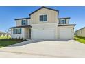 Two-story house with beige siding, blue shutters, and a three-car garage at 13868 Richland Gulf Cir, Parrish, FL 34219