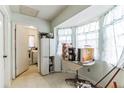Small kitchen area with white cabinets and a round table at 1450 Ward St, North Port, FL 34288