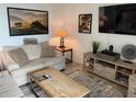 Relaxing living room featuring a comfy sofa and stylish decor at 43020 Greenway Blvd # 313, Punta Gorda, FL 33982
