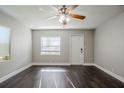 Bright living room with dark hardwood floors and ceiling fan at 4675 20Th S Ave, St Petersburg, FL 33711