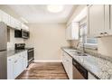 Modern kitchen with granite countertops and updated cabinetry at 6412 Skyline Ct, Spring Hill, FL 34606