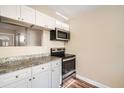 Renovated kitchen featuring granite countertops and stainless steel appliances at 6412 Skyline Ct, Spring Hill, FL 34606