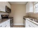 Modern kitchen with stainless steel appliances and granite counters at 6009 N 39Th St, Tampa, FL 33610