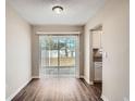 Dining area with wood-look vinyl flooring and a sliding glass door to the backyard at 5405 Mariner Blvd, Spring Hill, FL 34609
