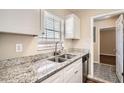 Kitchen with granite countertops, white cabinets, and stainless steel appliances at 5405 Mariner Blvd, Spring Hill, FL 34609