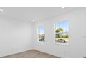 Bright office space with large windows and wood-look tile floors at 1078 Signet Dr, Apollo Beach, FL 33572