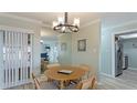 Bright dining room with table for four and view into kitchen at 524 Beach Rd # A, Sarasota, FL 34242