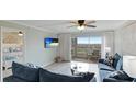 Living room with comfortable seating, access to patio, and ocean views at 524 Beach Rd # A, Sarasota, FL 34242
