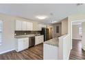 Modern kitchen with white cabinets, granite counters, and stainless steel appliances at 6256 Kimball Ct, Spring Hill, FL 34606