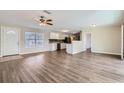 Open living room and kitchen with wood-look flooring at 6256 Kimball Ct, Spring Hill, FL 34606