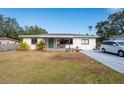 A renovated single story home with a covered porch and well maintained lawn at 1344 Springdale St, Clearwater, FL 33755