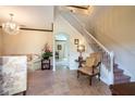 Elegant staircase with white railings and view to living room at 20102 Blue Daze Ave, Tampa, FL 33647