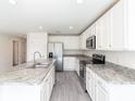 Modern kitchen with granite countertops and stainless steel appliances at 22162 Seaton Ave, Port Charlotte, FL 33954