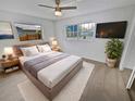 Main bedroom with plush carpet, ample natural light, and a ceiling fan at 11397 86Th Ave, Seminole, FL 33772