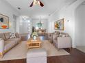 Bright living room with hardwood floors, comfortable seating, and large windows at 7431 39Th E Ct, Sarasota, FL 34243
