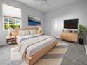 Light and airy bedroom with a large bed and plenty of closet space at 7431 39Th E Ct, Sarasota, FL 34243