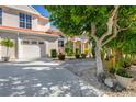 Two-story home with white garage door and landscaping at 818 Via Tripoli, Punta Gorda, FL 33950