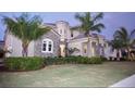 Two-story home with stone accents and palm trees at 811 Manns Harbor Dr, Apollo Beach, FL 33572