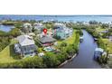 Wide aerial showcasing the home, pool, canal, and waterfront at 505 Sally Lee Dr, Ellenton, FL 34222
