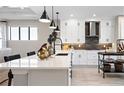 Modern kitchen with white cabinets, quartz countertops, and a large island at 14370 Hammock Oak St, Parrish, FL 34219