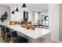 Modern kitchen featuring white cabinets, quartz countertops, and an island at 14370 Hammock Oak St, Parrish, FL 34219