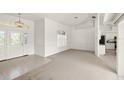 Open living room with a view of the kitchen and foyer at 15392 Taurus Cir, Port Charlotte, FL 33981
