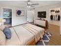 Bright bedroom with a large bed, dresser, and walk-in closet at 2587 Forest Run Ct # 141B, Clearwater, FL 33761