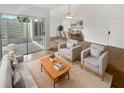 Bright living room with hardwood floors, and access to a screened patio at 2587 Forest Run Ct # 141B, Clearwater, FL 33761