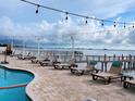 Pool deck with lounge chairs and waterfront views at 1420 Bayshore Blvd # 316, Dunedin, FL 34698