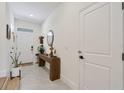 Bright and airy entryway with wood console table and large mirror at 8955 Milestone Dr, Sarasota, FL 34238