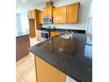 Kitchen features granite countertops and modern appliances at 1403 Custer Bayou St, Ruskin, FL 33570