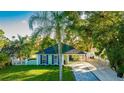 Attractive light green house with a paved driveway and manicured lawn at 2246 Goldenrod St, Sarasota, FL 34239