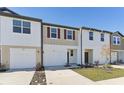 Two-story townhome with attached garage and front yard at 6188 Pina Colada St, Zephyrhills, FL 33542