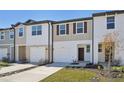 Two-story townhome with attached garage, and landscaping at 6188 Pina Colada St, Zephyrhills, FL 33542