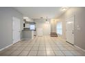 Open dining area with tile floors and access to kitchen at 7707 N Riverdale Ave, Tampa, FL 33604