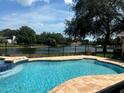 Inviting pool with spa and lake view at 8950 Baywood Park Dr, Seminole, FL 33777