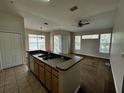 Open kitchen with breakfast bar and dark countertops at 5707 Legacy Crescent Pl # 303, Riverview, FL 33578