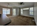 Spacious living room with large windows and ceiling fan at 5707 Legacy Crescent Pl # 303, Riverview, FL 33578