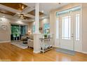 Bright entryway with hardwood floors and a view into living room at 7313 Emma Rd, Bradenton, FL 34209