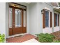 Brown front door with sidelights and a brick walkway at 7313 Emma Rd, Bradenton, FL 34209