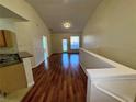 Open living area with wood-look floors and a breakfast bar at 10412 Villa View Cir, Tampa, FL 33647